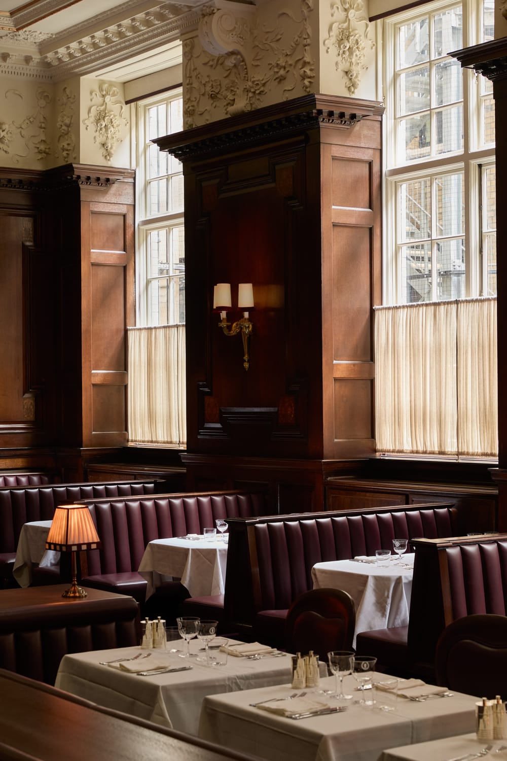 Elegant dining room at Grand Divan London with bespoke banquette seating