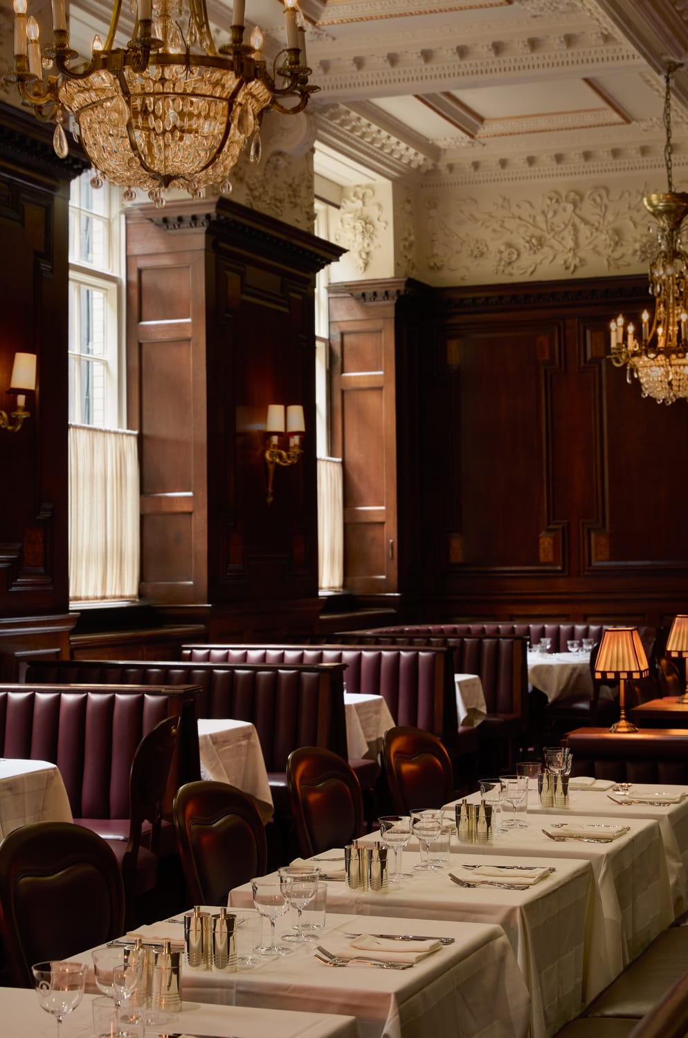 Elegant dining room at Grand Divan London with bespoke banquette seating