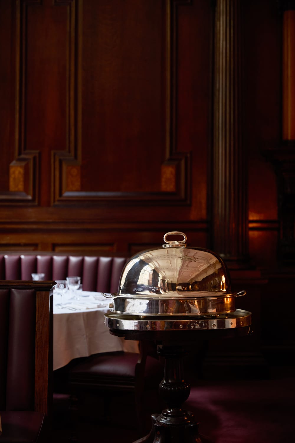 Silver carving trolley beside leather banquettes
