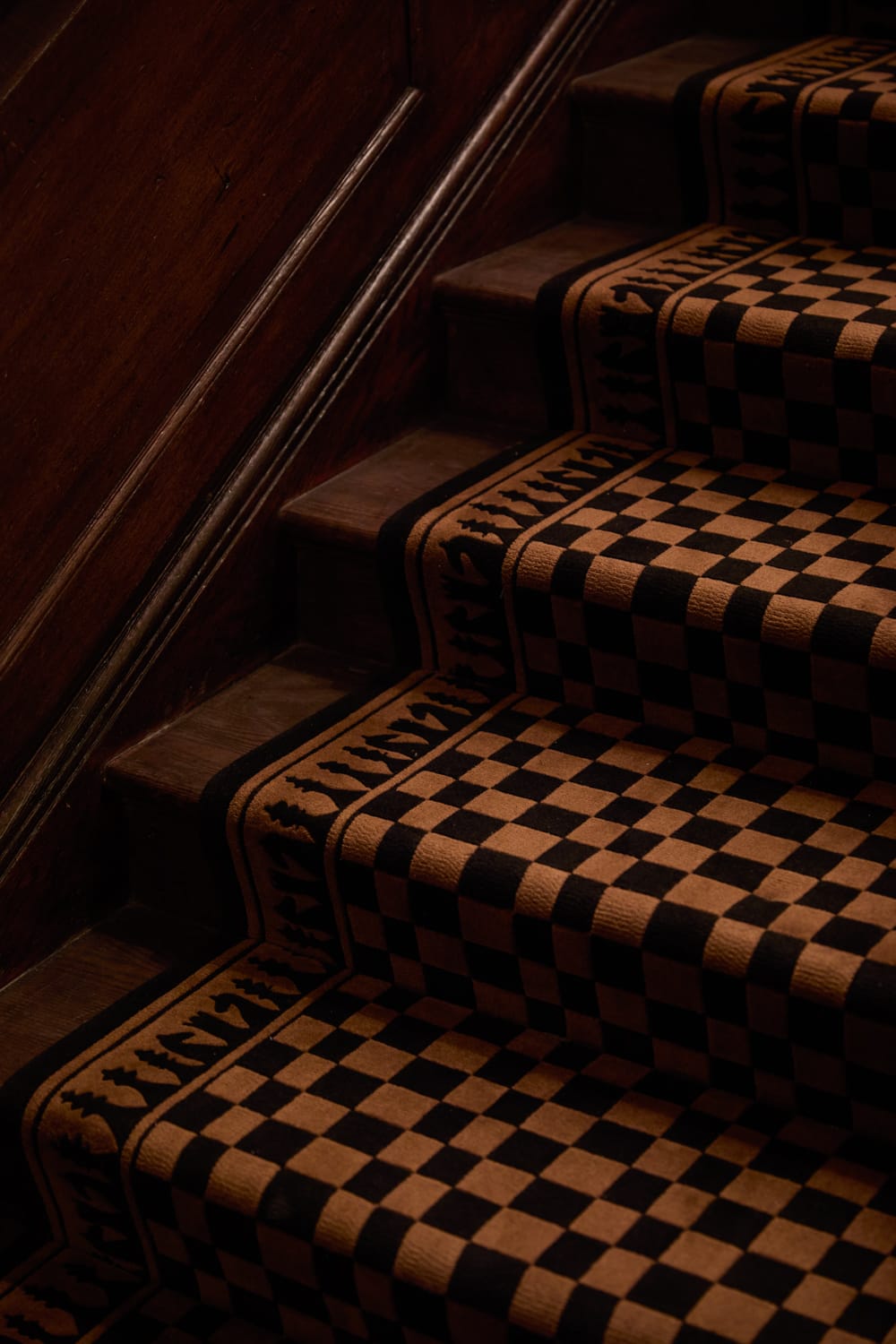 Bespoke chequerboard stair runner within Simpsons in The Strand London