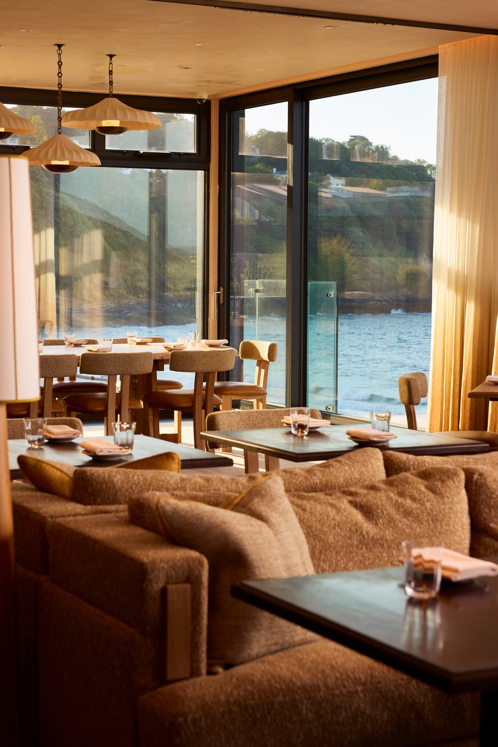 Dining tables beside full-height glazing at MOR Carbis Bay
