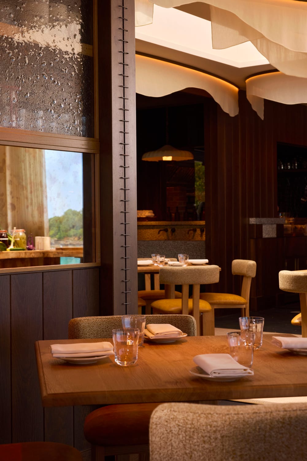 View through the dining room towards the open kitchen at MOR Carbis Bay